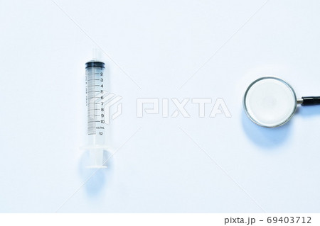 syringe and stethoscope medical equipment for doctor listening pulse of patient on white background syringe and stethoscope medical equipment for doctor listening pulse of patient on white background 69403712
