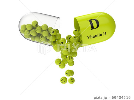 Open capsule with vitamin D from which the vitamin composition is pouring 69404516