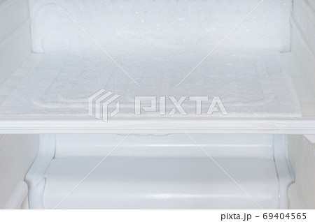 Ice buildup inside of empty of a refrigerator. Ice buildup inside of empty of a refrigerator. 69404565