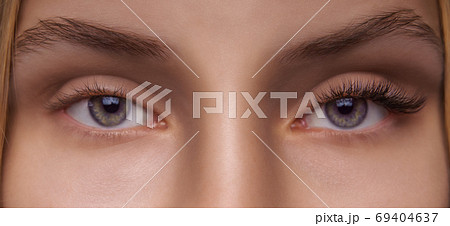 Eyelash Extension Procedure. Woman Eye with Long Eyelashes. Close up, selective focus. Eyelash Extension Procedure. Woman Eye with Long Eyelashes. Close up, selective focus. 69404637