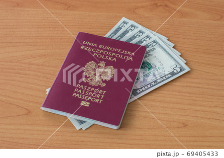 Polish biometric passport with five dollars banknotes. 69405433