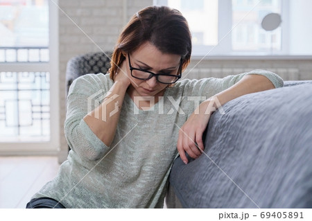 Sad depressed age lonely woman sitting on floor Sad depressed age lonely woman sitting on floor 69405891