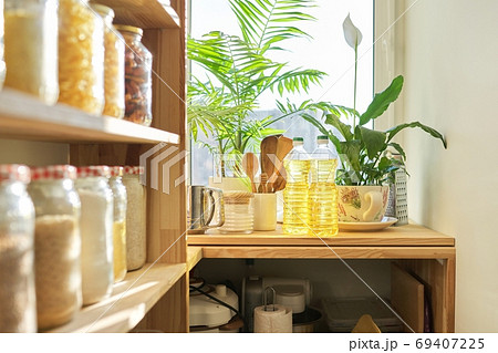 Kitchen utensils, sunflower oil on wooden table in pantry, food storage at home Kitchen utensils, sunflower oil on wooden table in pantry, food storage at home 69407225