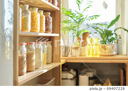 Kitchen utensils, sunflower oil on wooden table in pantry, food storage at home 69407226