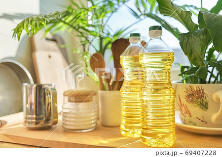 Kitchen utensils, sunflower oil on wooden table in pantry Kitchen utensils, sunflower oil on wooden table in pantry 69407228