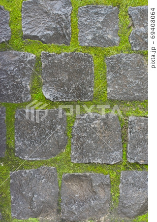 Background, texture, stone vintage square stones with light green mossy seams 69408064