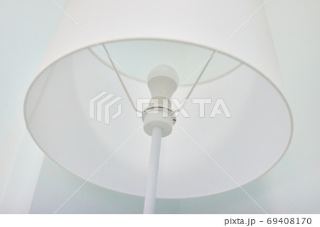 White elegant modern floor lamp in white interior. Closeup textile top of floor lamp 69408170