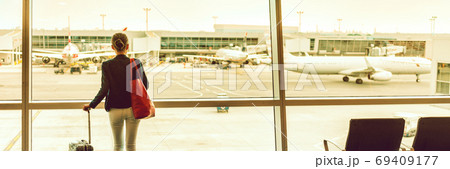 Traveler businesswoman at airport banner Traveler businesswoman at airport banner 69409177
