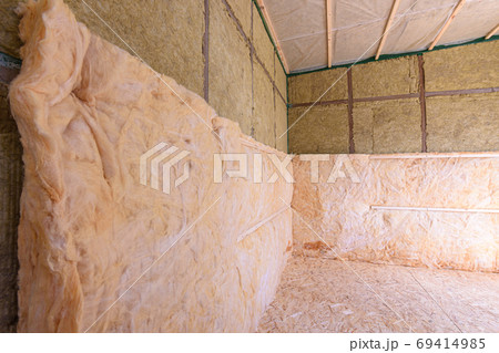 Combination of roll and thermal insulation with plates in a country wooden house 69414985