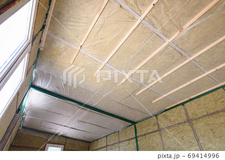 Insulation of the roof from the inside with mineral wool in a wooden country house 69414996