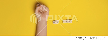 MeToo on wooden alphabet, used for concept of sexual harrassment. Woman fist as protest in shot MeToo on wooden alphabet, used for concept of sexual harrassment. Woman fist as protest in shot 69416593