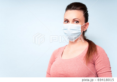 Health And Infection concept. Yang Woman wears Medical Face Mask against flu and viruses. Healthcare Health And Infection concept. Yang Woman wears Medical Face Mask against flu and viruses. Healthcare 69418015