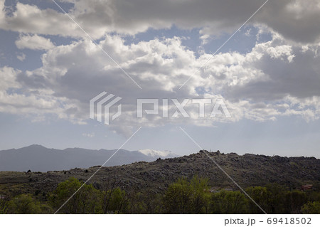 Landscape of a valley at the foot of a mountain 69418502