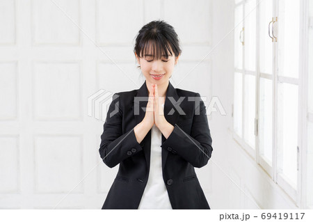 お願いのジェスチャーをする若いビジネスウーマン 69419117