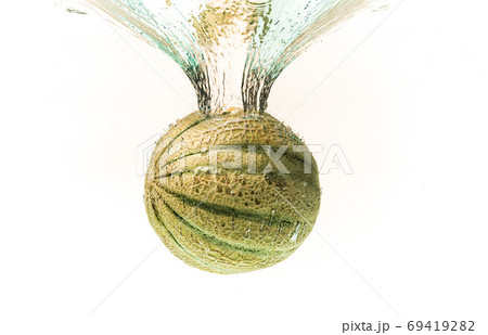Cantaloupe melon splashing into water isolated on white background 69419282