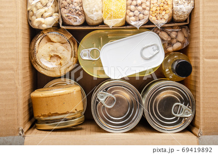 Flat lay view at groceries in carton box prepared for disaster e Flat lay view at groceries in carton box prepared for disaster e 69419892