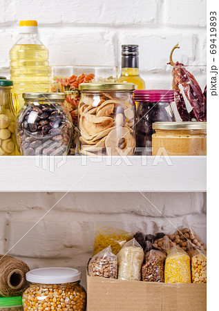 Set of non-perishable foods on pantry shelf on brick wall backgr Set of non-perishable foods on pantry shelf on brick wall backgr 69419893