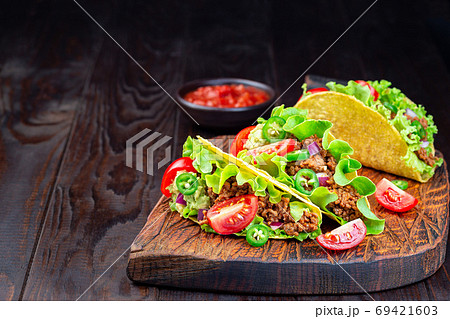 Taco with ground beef meat, mashed avocado, tomato Taco with ground beef meat, mashed avocado, tomato 69421603