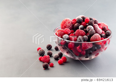 Frozen berries in a glass bowl, raspberry, strawberry 69421613