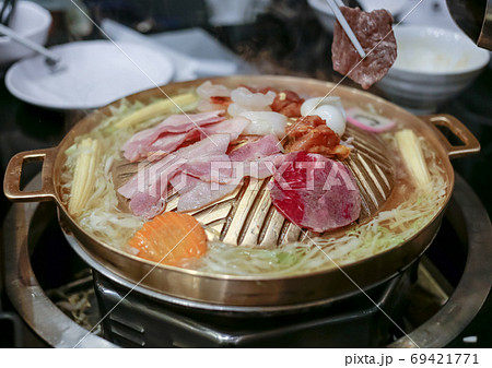 Pork, Shredded carrot, Shredded cabbage grill on BBQ brass pan, focus selective. Pork, Shredded carrot, Shredded cabbage grill on BBQ brass pan, focus selective. 69421771