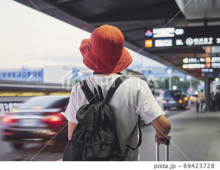 Solo traveler carry luggage walking in airport 69423728