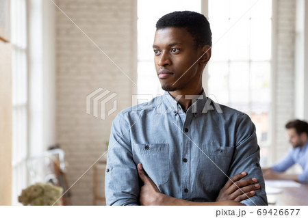 Pensive african American man look in distance thinking 69426677