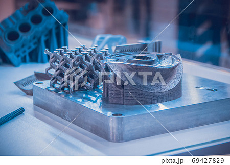 Man is holding object printed on metal 3d printer. 69427829