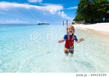 Kids playing on beach. Children play at sea. Kids playing on beach. Children play at sea. 69429299