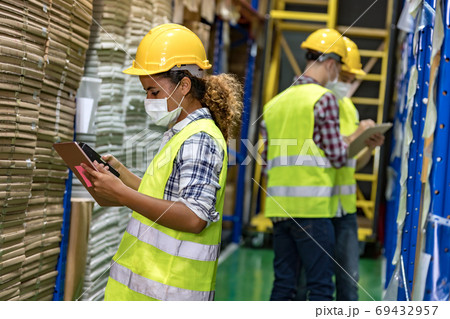African black warehouse worker do inventory. 69432957