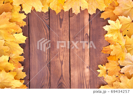 Autumn leaves frame on wooden background top view 69434257