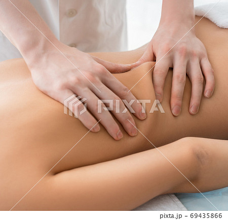 Nude woman being massaged cropped view 69435866