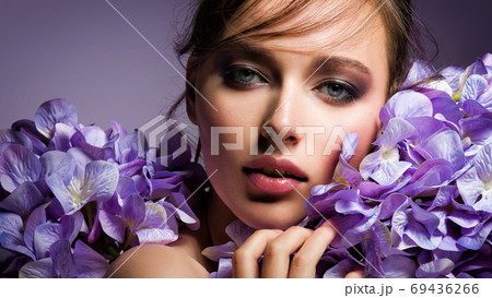 Pretty woman with bright makeup. Beautiful white girl with flowe 69436266