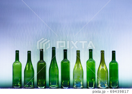 abstract empty wine bottles with blue led illumination 69439817