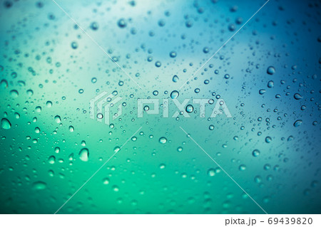 water drops on glass window, green and blue background 69439820