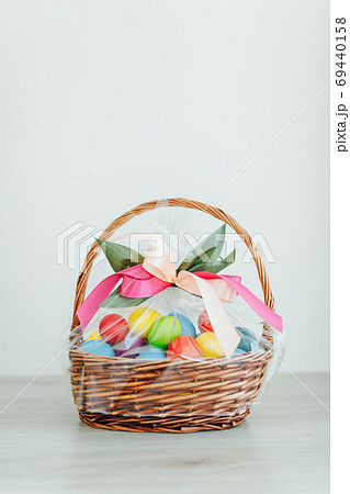 Easter color eggs in festive gift basket Easter color eggs in festive gift basket 69440158