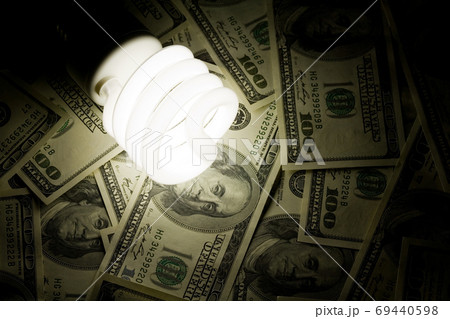 Compact Fluorescent Light bulb and dollar Compact Fluorescent Light bulb and dollar 69440598