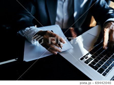 business man in suit in front of laptop with book work communication technology business man in suit in front of laptop with book work communication technology 69442040