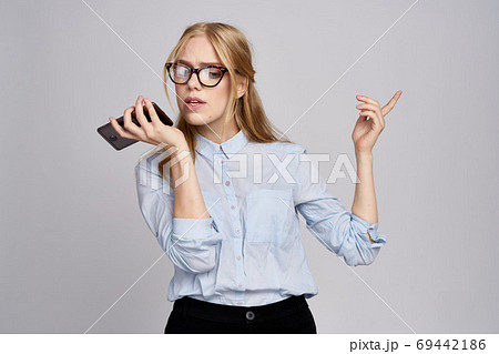 business woman in glasses on a light background gestures with hands Copy Space work documents business woman in glasses on a light background gestures with hands Copy Space work documents 69442186