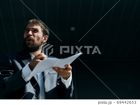 Business man outdoors with documents in hands near building official lifestyle 69442653