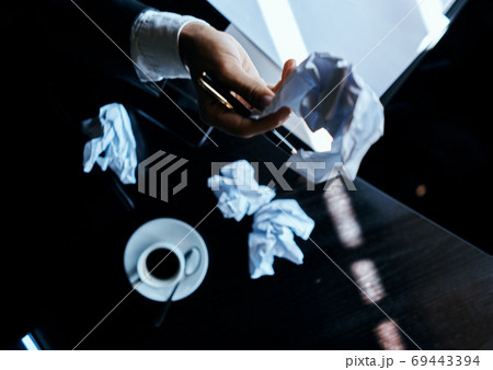 Cafe papers on the table crumpled paper coffee cup executive businesswoman lifestyle Cafe papers on the table crumpled paper coffee cup executive businesswoman lifestyle 69443394