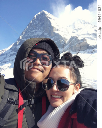Young couple taking a selfie on snow mountain in Switzerland Young couple taking a selfie on snow mountain in Switzerland 69444024