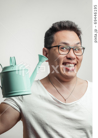 Happy funny Asian man in his 30s in white usual t-shirt with different positive emotions Happy funny Asian man in his 30s in white usual t-shirt with different positive emotions 69446195