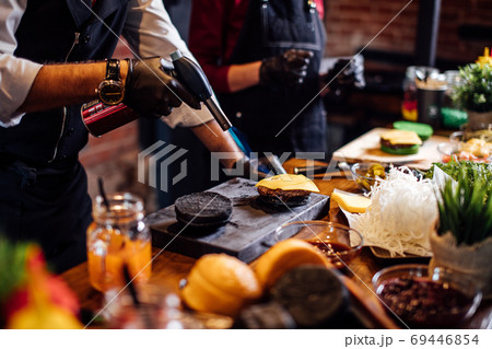 Chef making beef burgers at burger pub 69446854