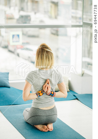 Woman doing yoga exercise on mat in Virasana or Hero Pose 69447738