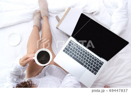 Close up legs women on white bed in the bedroom. Close up legs women on white bed in the bedroom. 69447837