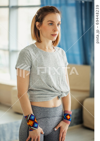 Side view of strong woman standing in the gym. Preparing to workout. 69448239