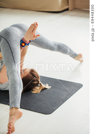 Young Fit Woman Doing a Yoga Pose Standing with One Leg Raised Up