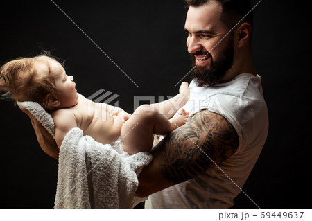 Father holding on hands cute little baby. Family, love and happiness concept Father holding on hands cute little baby. Family, love and happiness concept 69449637