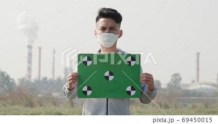 man hold green billboard man hold green billboard 69450015