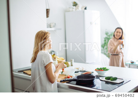 Closeup of woman roasting kebabs on frying pan 69450402